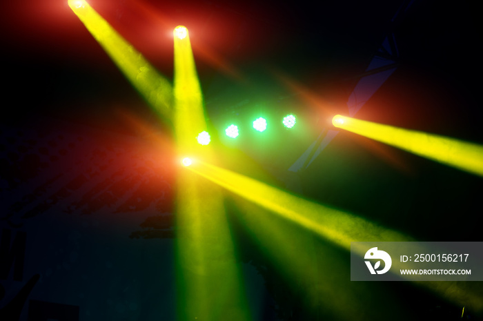 light rays on a dark background of the stage during a rock concert, blurred background.