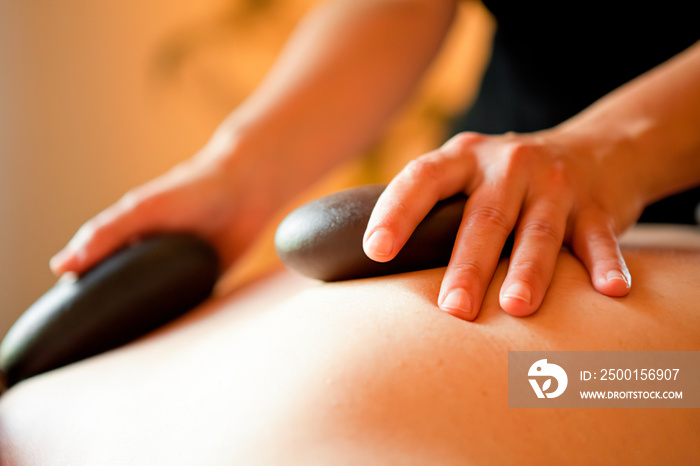 Balinese massage with hot LAVA stones. It relaxes and brings relief. It improves blood circulation.