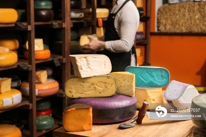 Different cheeses on table in shop