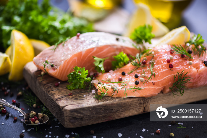 salmon steaks on wooden board marinated