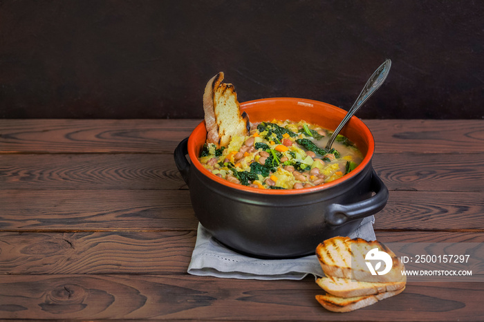 Ribollita - a famous Tuscan bread soup,  the main ingredients are:  leftover bread, beans, lacinato kale, cabbage,  carrot,  celery, potatoes and onion.