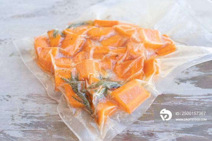 Vacuum sealed bag with carrots ready for low temperature cooking or sous vide