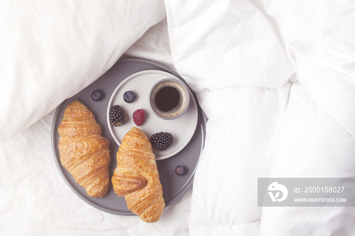 Breakfast in bed with coffee, croissant