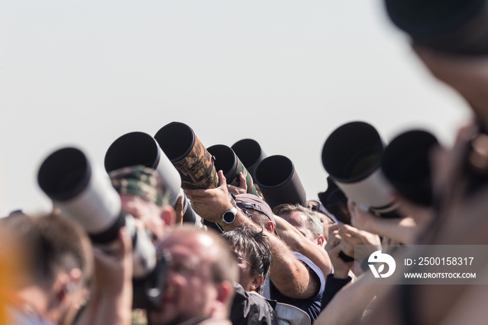 Photographers taking photos of an airplanes - lenses pointing up