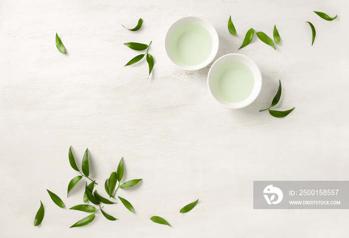 Two white cups of tea, view from above background