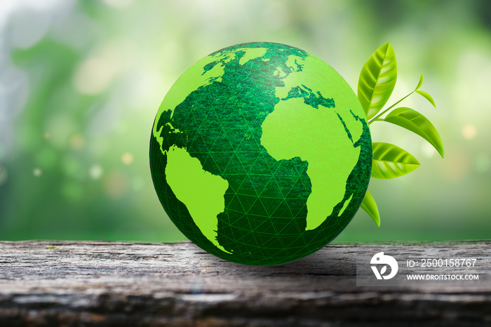 Green globe on wooden floor and natural background bokeh blur. The concept of loving the earth and the environment.