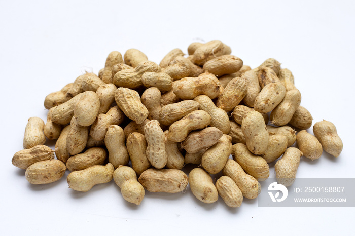 Raw peanuts on white background.