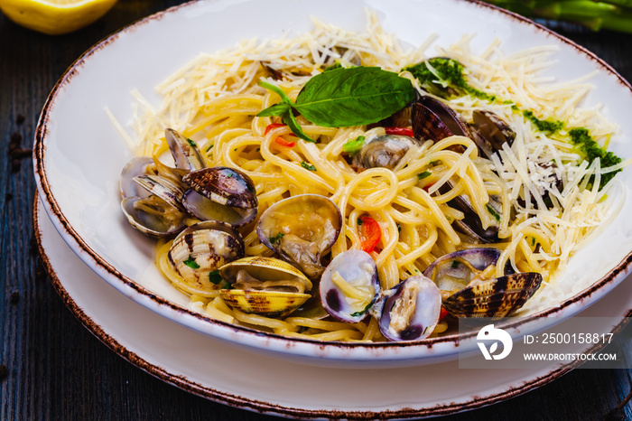 Italian food. Seafood pasta with clams. Spaghetti alle Vongole on white plate.