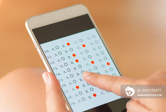 student testing in exercise, exams answer on smart phone with mu