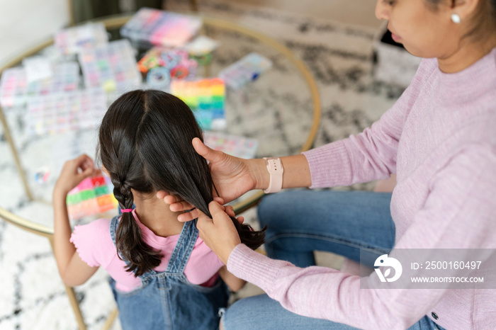 Mother doing daughter braids