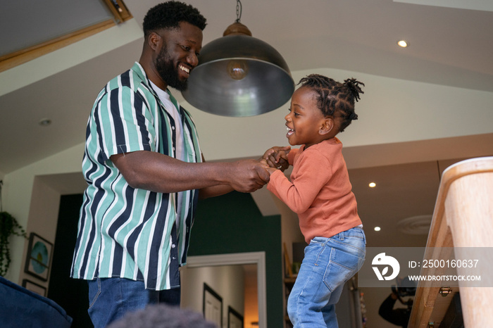 Father and daughter (2-3) having fun at home