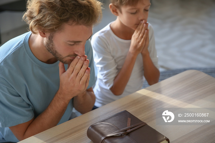 Father with son praying at home