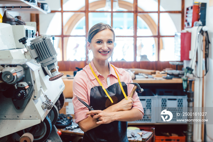 Business portrait of owner in her small cobbler workshop