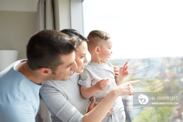 happy family looking through window at home