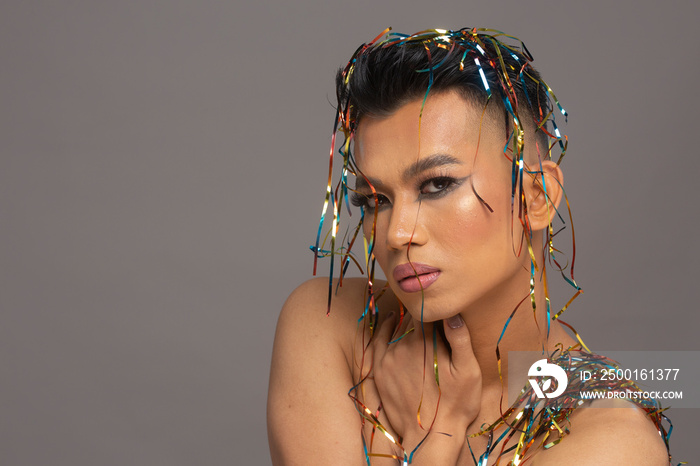 Studio portrait of person with shiny serpentines on head