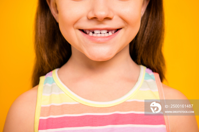 Cropped photo of charming kid having toothy smile wearing tank-top isolated over yellow background