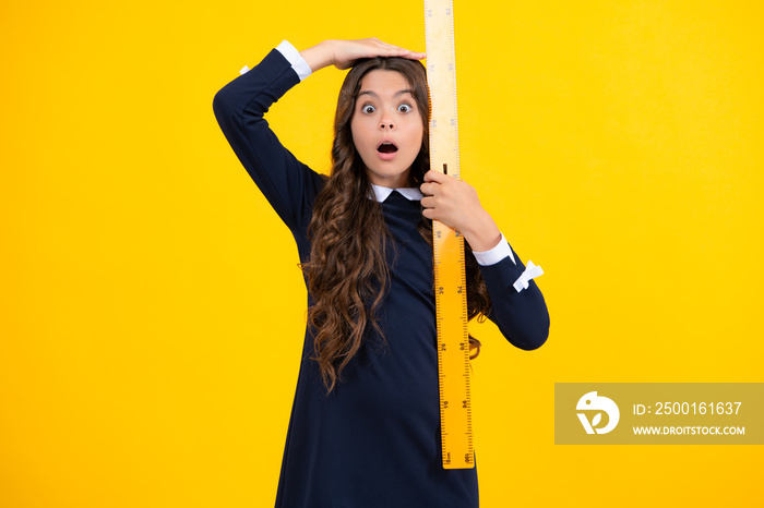 Back to school. Teenager school girl on yellow background. School supplies. Surprised emotions of young teenager girl.