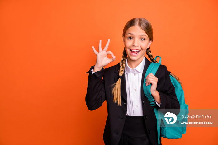 Close up photo beautiful she her little lady funny hairdo hand arm fingers raised okey symbol approval quality news wear formalwear shirt blazer skirt school form bag isolated bright orange background