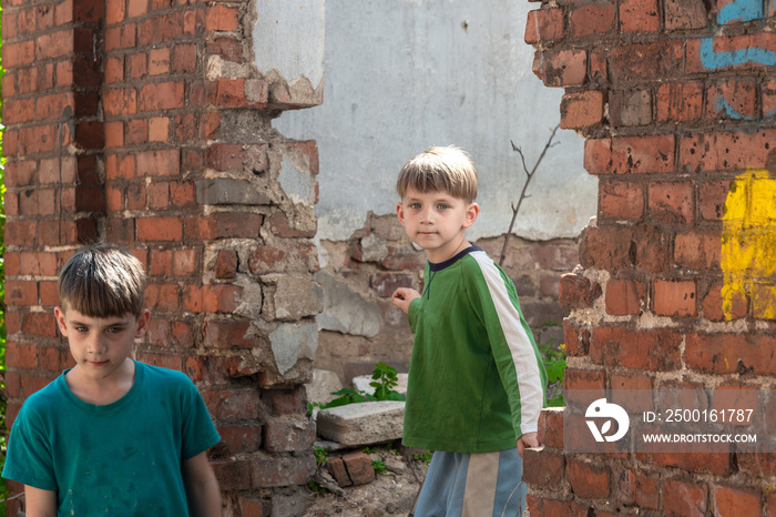 Children in an abandoned house, two poor abandoned boys, orphans as a result of natural disasters and military actions. Submission photo.