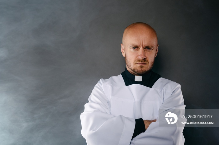 Priest in white surplice and black shirt with cleric collar