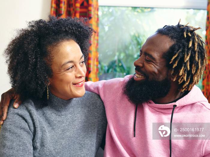 Couple embracing, looking at each other