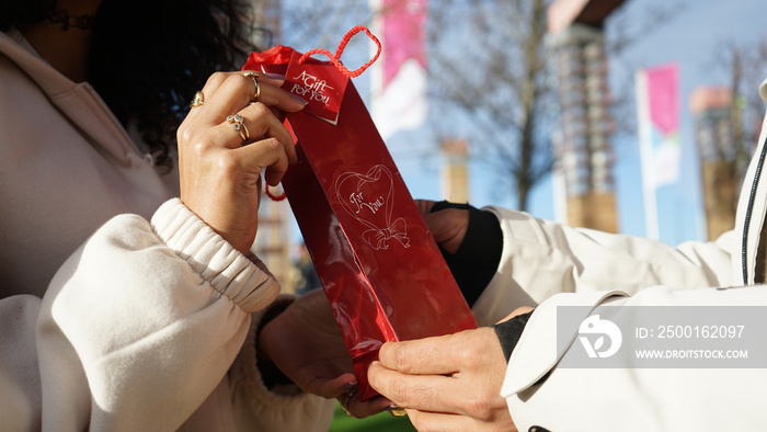 Close-up of hands of couple holding gift