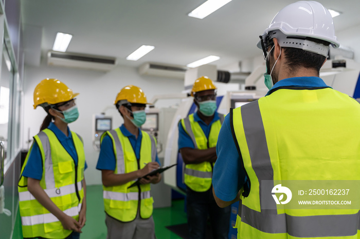 Factory workers meeting before work And put on a mask