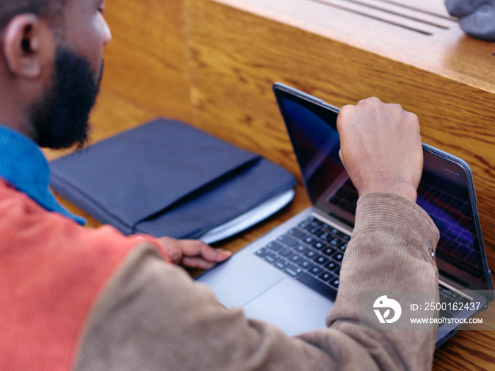 Close-up of businessman opening laptop