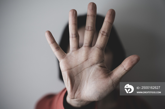 Young woman showing her denial, or saying NO with her hand