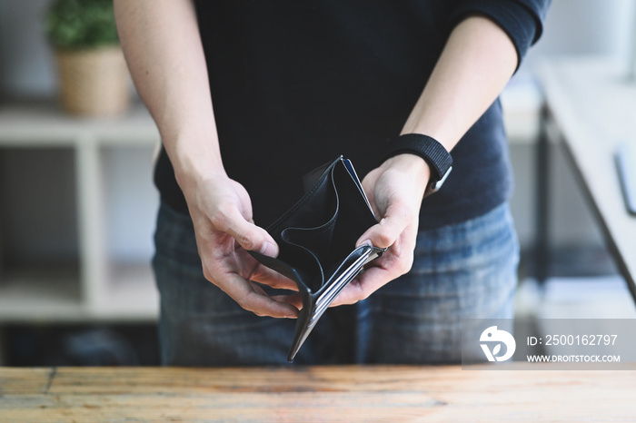 Man holding empty wallet. Bankruptcy, unemployment and financial crisis concept.