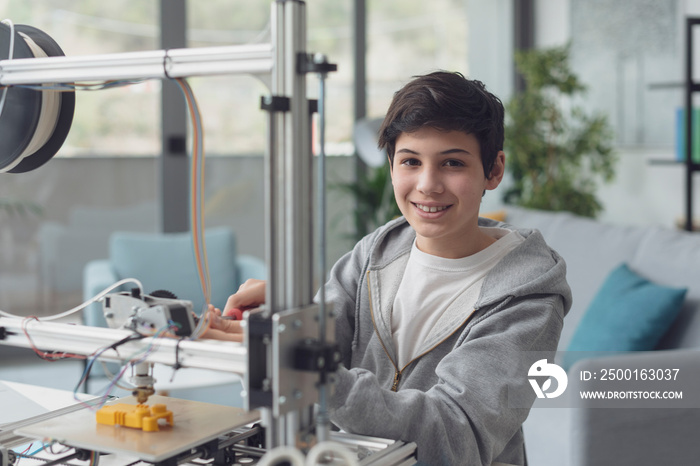 Smart boy using a 3D printer at home