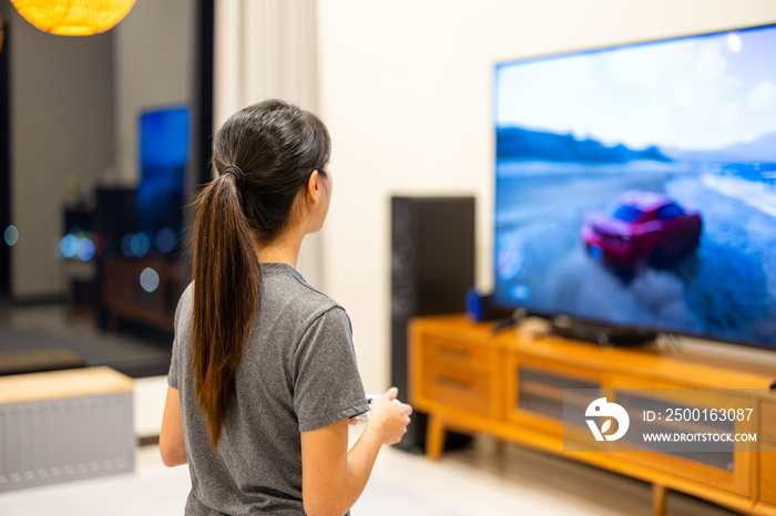 Woman play TV video game at home