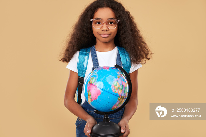 African kid with globe during lesson