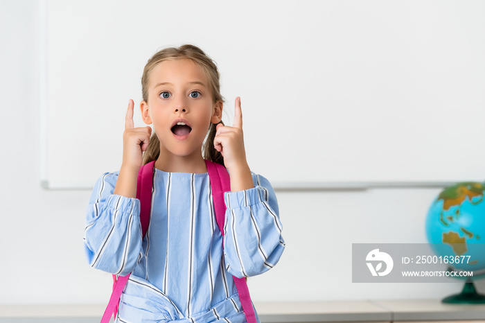 Excited schoolgirl having idea in classroom of stem school