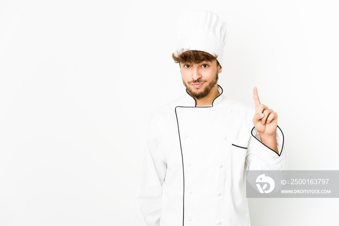 Young arab cook man showing number one with finger.