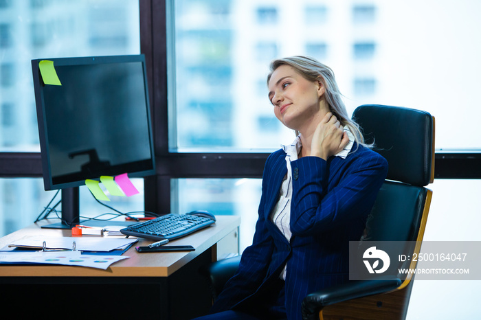 Business woman feeling pain in neck after sitting at desk. business woman Office syndrome