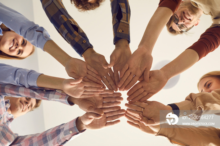 Happiness and leisure, group psychotherapy session for rehabilitation concept. Close up bottom view of teenage people young friends hold hands together in circle show teamwork and collaboration