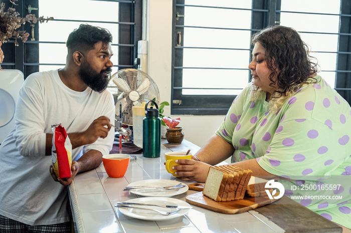 Couple making breakfast together at home in the morning