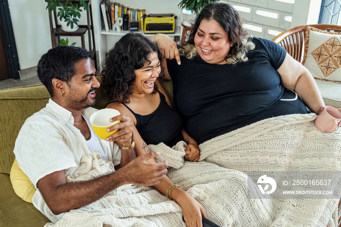 Friends watching tv together at home