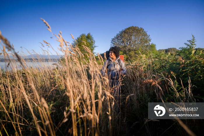 U.S. Army female soldier putting in the miles with an early morning hike in the NorthWest.