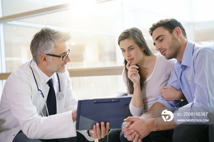 Couple meeting medical specialist at hospital