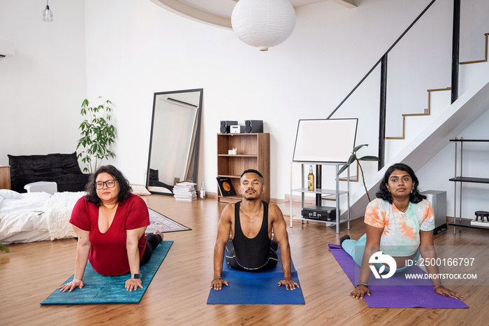 Group of friends meditating and doing yoga at home