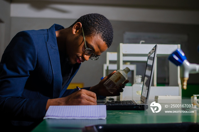 The pharmacist is reviewing the list of drugs and checking the stock of all medicines at one