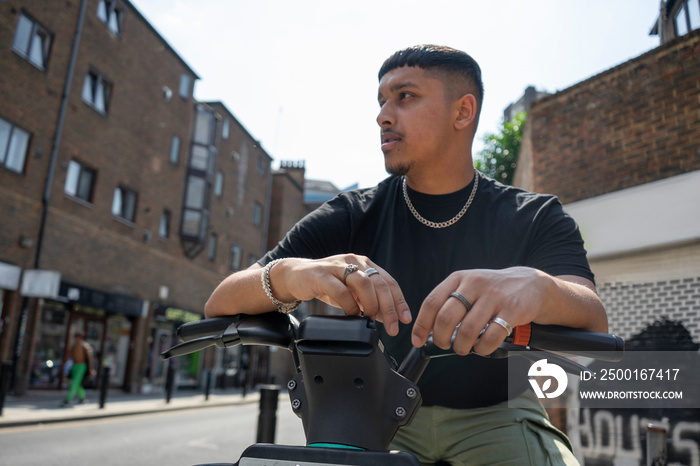 Man sitting on bike and looking away