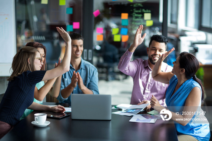 Team of businesspeople giving high five