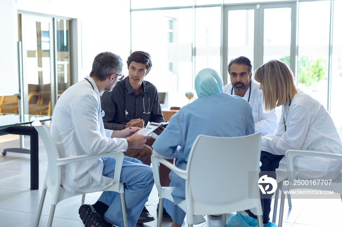 Medical team discussing with each other in hospital