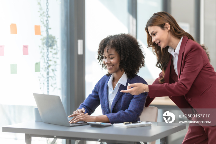 Young trader mixed race woman in formal suit friends consulting and discussing with stock market and cryptocurrency in online trading application.