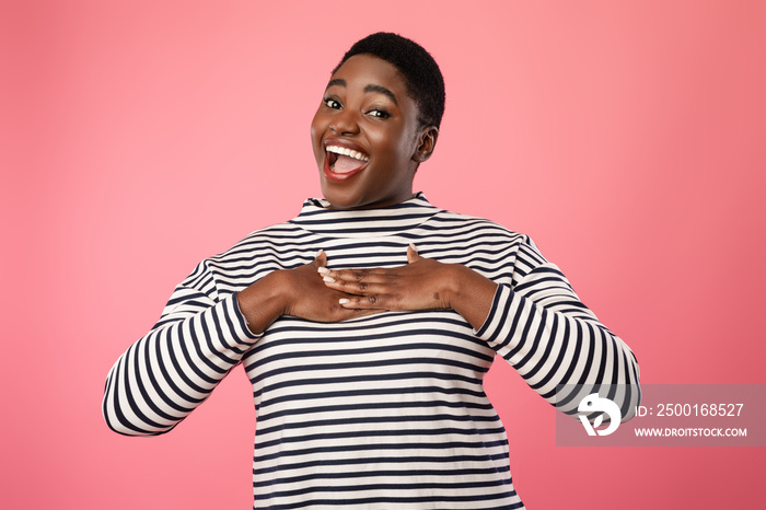 Overweight African American Female Pressing Hands To Chest, Pink Background