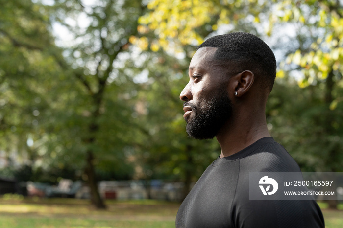 Profile of athletic man standing in park