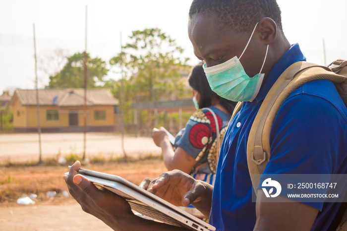 black people, travelers, wearing face masks, standing outdoors